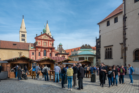 Prague, Czech Republic - April 4, 2018 : People in a market in Prague, eating and drinking, while easter in front of St. George s Basilicaのeditorial素材