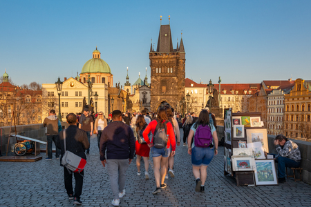 Prague, Czech Republic - April 4, 2018 : View of the Charles Bridge and the old tower by the river, with tourists visiting.のeditorial素材