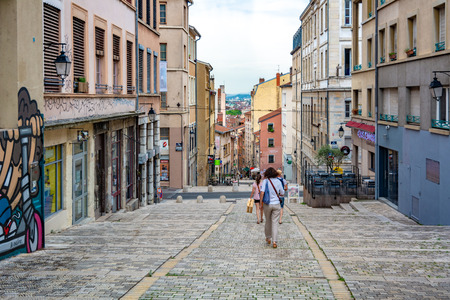 Lyon, France - July 19, 2018: Tourists in a charming alley in Vieux Lyon, the old town of Lyon that is part of the UNESCO world heritage siteのeditorial素材