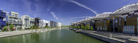 Lyon, France - July 18, 2018: Tourists near confluence Shopping and Leisure Center with a river and modern buildings.のeditorial素材