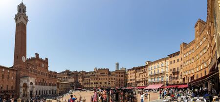 Siena, Italy - June 7, 2019 : The Torre del Mangia is a tower located in the Piazza del Campo, adjacent to the Palazzo Pubblico (Town Hall). When built it was one of the tallest secular towers in medieval Italy.のeditorial素材