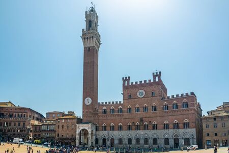 Siena, Italy - June 7, 2019 : The Torre del Mangia is a tower located in the Piazza del Campo, adjacent to the Palazzo Pubblico (Town Hall). When built it was one of the tallest secular towers in medieval Italy.のeditorial素材