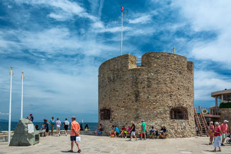 Saint-Tropez, France - June 11, 2019 : The 15th Century Portalet Tower stands at the beginning of the great pier and is overlooking the creek of La Glaye in Saint-Tropez, Var, France.のeditorial素材