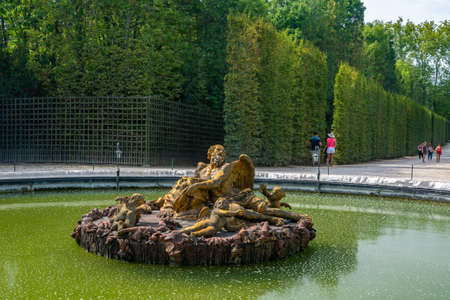 Versailles, France - August 27, 2019 : Gorgeous view of the Saturn Fountain, an allegory of Winter in the background in the Gardens of Versailles.のeditorial素材