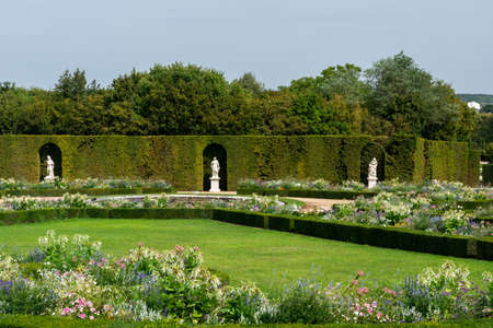 Versailles, France - August 28, 2019: Panoramic of North Parterre in Versailles Gardens with statues, vases and trimmed bushes.のeditorial素材