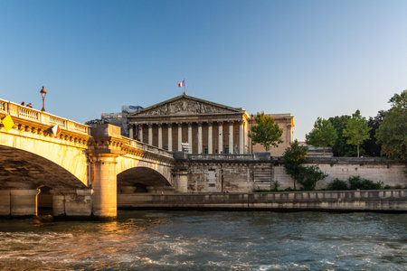 Paris, France - August 29, 2019: People walking on the Pont de la Concorde bridge nearthe Assemblee Nationale at sunset in Parisのeditorial素材