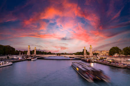 Paris, France - August 29, 2019: Pont Alexandre III bridge over river Seine, decorated with ornate Art Nouveau lamps and sculptures. The Alexander III Bridge across Seine river in Paris, France.のeditorial素材