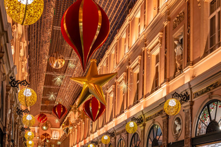 Brussels, Belgium - Nov 30, 2025: Close up view of festive Christmas ornaments and warm golden lights inside the Galeries Royales Saint Hubert.のeditorial素材