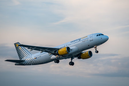 Brussels, Belgium - Dec 21, 2025: Vueling Airbus A320 passenger jet taking off from Brussels Airport...