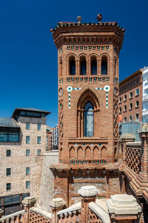 Teruel, Spain - August 15, 2022: Close-up of a Mudejar-style tower from the Escalinata del Ovalo, featuring intricate brick and tile work under clear blue sky.のeditorial素材