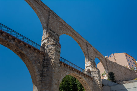 Teruel, Spain - August 15, 2022: Low angle view of the 16th-century Los Arcos aqueduct, a historic landmark combining bridge and water channelのeditorial素材