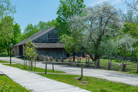 Toronto, ON, Canada â May 15, 2022: View at the street in the open-air heritage museum Black Creek Pioneer Village in Toronto, Ontario, Canada. The village is a recreation of life in 19th-century Ontario and gives an idea of how rural Ontario might haveのeditorial素材