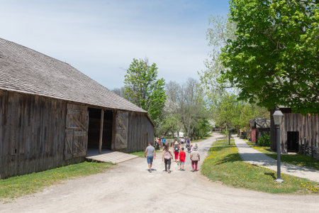 Toronto, ON, Canada â May 15, 2022: Visitors walk on the street in  the open-air heritage museum Black Creek Pioneer Village in Toronto, Ontario, Canadaのeditorial素材