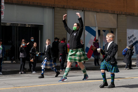 Toronto, ON, Canada â€“ March 20, 2022: People Take Part in the St Patrick's Day Parade in...