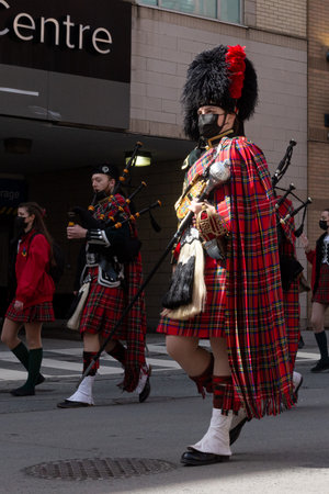 Toronto, ON, Canada â€“ March 20, 2022: Drummers and Pipers Take Part in a St Patrick's Day...
