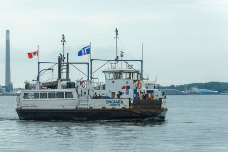 Toronto, ON, Canada - August 21, 2022: A Ferry departs from Toronto Jack Layton Terminal in the city...