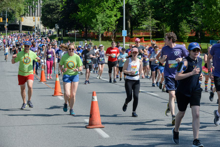 Toronto, ON, Canada - June 22, 2019: Runner takes part in amateur sports run competition during the Pride month in Torontoのeditorial素材