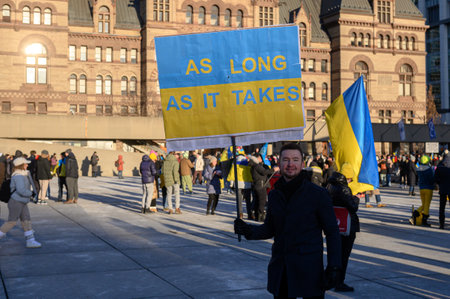 Toronto, Ontario, Canada â February 24, 2024:  Protestors with banners and Ukrainian flags in Downtown Nathan Phillips Square during the demonstration against the Russian invasion of Ukraineのeditorial素材