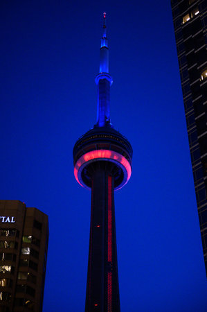 Toronto, ON, Canada - February 24, 2024: CN Tower is illuminated in the blue and yellow colours of Ukraine's flag, as solidarity is shown with the country, ahead of the anniversary of Russia's invasion of Ukraineのeditorial素材