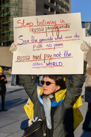 Toronto, Ontario, Canada â February 24, 2024:  Protestors with banners and Ukrainian flags in Downtown Nathan Phillips Square during the demonstration against the Russian invasion of Ukraineのeditorial素材