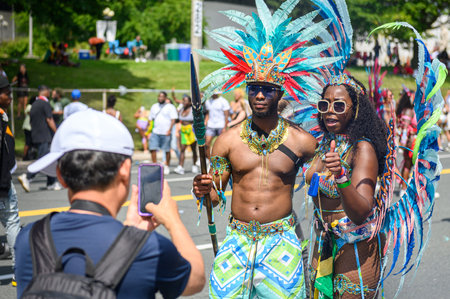 Toronto, ON, Canada - August 5, 2023: Man takes photo of  participant dressed in glittering...