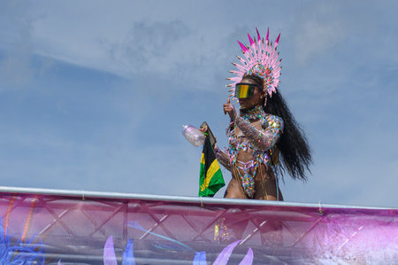 Toronto, ON, Canada - August 5, 2023: parade participant dressed in glittering feathered parade...