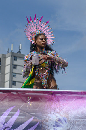 Toronto, ON, Canada - August 5, 2023: parade participant dressed in glittering feathered parade...