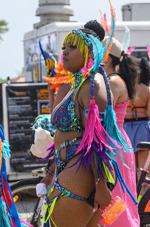 Toronto, ON, Canada - August 5, 2023: parade participant dressed in glittering feathered parade...
