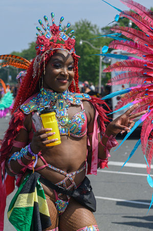 Toronto, ON, Canada - August 5, 2023: parade participant dressed in glittering feathered parade...