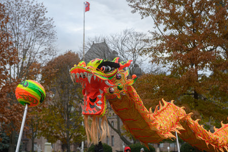TORONTO, ONTARIO, CANADA - NOVEMBER 23, 2025: A colourful traditional Chinese Dragon Dance performance proceeds along the route of The Original Santa Claus Paradeのeditorial素材