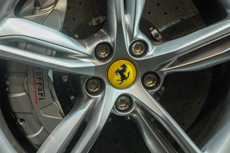 Toronto, ON, Canada - March 15, 2025: A Ferrari emblem is displayed on the alloy wheel of a red...