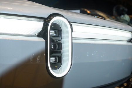Toronto, ON, Canada - March 15, 2025: A Rivian emblem is displayed on the vertical LED headlight of...