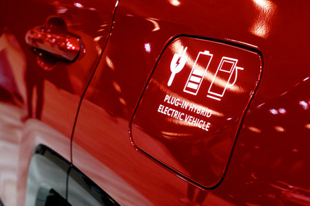 Toronto, ON, Canada - March 15, 2025: A close-up of a Battery Electric Vehicle (BEV) charging port cover, featuring a plug and battery icon, indicating an all-electric drivetrainのeditorial素材
