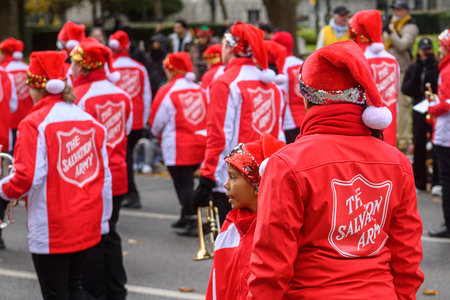 Toronto, ON, Canada - November 23, 2025: Participants from The Salvation Army wear matching red jackets and Santa hats as they march in the 121st Original Santa Claus Parade.のeditorial素材