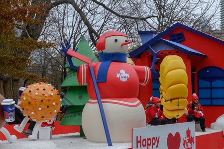 Toronto, ON, Canada - November 23, 2025: The Tim Hortons float, featuring a large snowman and Timbits characters, travels down the street during the 121st Original Santa Claus Parade.のeditorial素材