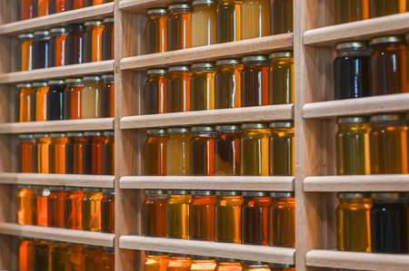 Toronto, ON, Canada - November 14, 2025: Rows of honey jars presenting diverse natural colors, a...