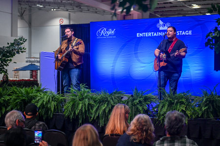 Toronto, ON, Canada - November 14, 2025: Two male musicians are playing acoustic guitars and singing on stage during a live concert at The Royal Agricultural Winter Fairのeditorial素材