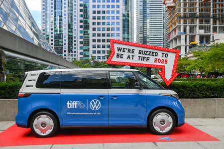 Toronto, ON, Canada - September 7, 2025: Electric van displaying brand logos and event partnership...