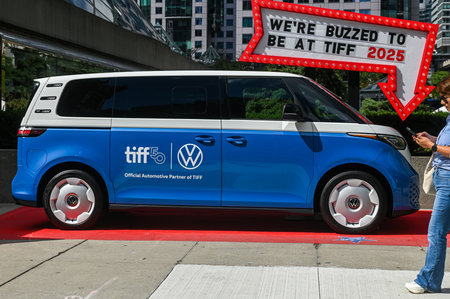 Toronto, ON, Canada - September 7, 2025: Electric van wrapped with film festival branding on a red...