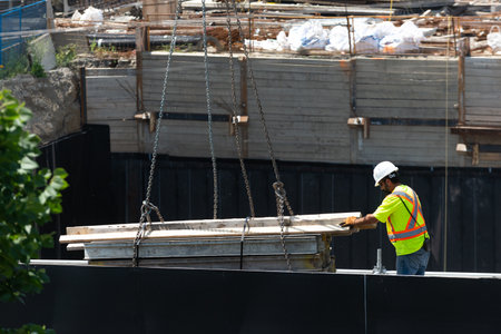 Toronto, ON, Canada - August 3, 2022: A worker works on the construction site of a house under...