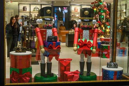 Toronto, ON, Canada - December 24, 2025: Nutcracker statues and festive gift boxes adorning a store window displayのeditorial素材