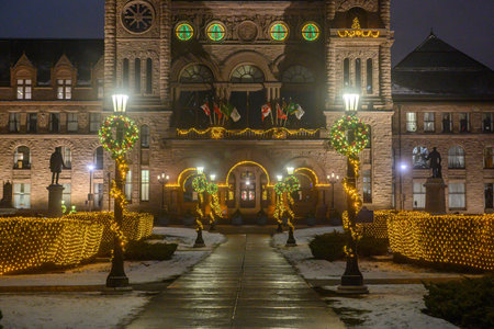 Toronto, ON, Canada - December 19, 2025: Ontario Parliament Building illuminated with Christmas lights, wreaths, and festive decorations in Toronto, Canadaのeditorial素材
