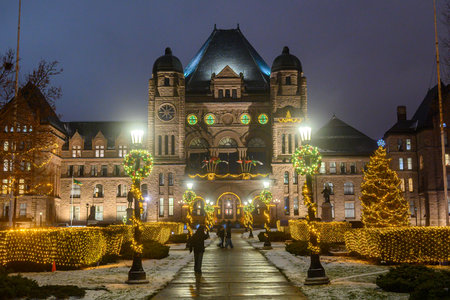 Toronto, ON, Canada - December 19, 2025: Ontario Parliament Building illuminated with festive lights, decorations, and a Christmas tree in Toronto at nightのeditorial素材