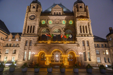 Toronto, ON, Canada - December 19, 2025: Ontario Parliament Building in Toronto illuminated with festive Christmas lights and flags during the winter holiday seasonのeditorial素材