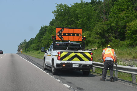 Toronto, ON, Canada - August 10, 2025: The crew works on the highway, providing road maintenance...