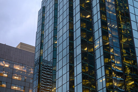 Toronto, ON, Canada - November 11, 2025: Office building with glass windows reflects the city...