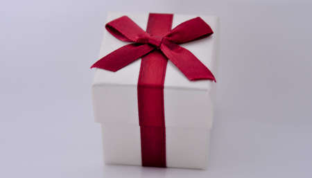 Gift box with red ribbon on white backgroundの写真素材
