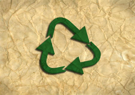Green 3D recycling logo on recycled paperの写真素材