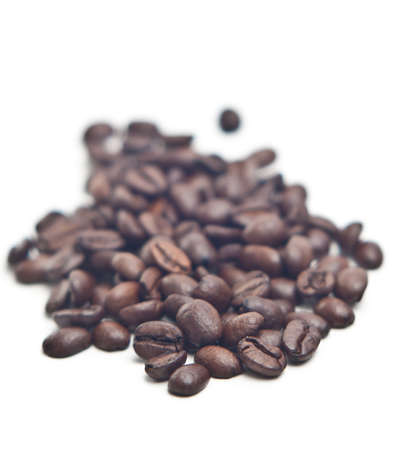 Stack of coffee beans isolated on white