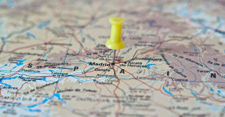 Push pin pointing at Madrid, Spain on a mapの写真素材